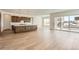 Open floor plan with modern kitchen, dark cabinets, a large island and hardwood floors at 483 Agoseris Way, Castle Rock, CO 80104