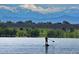 Community lake with paddle boarding against a backdrop of snow-capped mountains at 14454 E Colorado Dr # 102, Aurora, CO 80012
