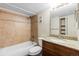 Well-lit bathroom featuring a bathtub, toilet, and a modern-style vanity at 14454 E Colorado Dr # 102, Aurora, CO 80012