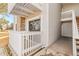 Exterior view of unit 102 with a private balcony, stone accents, and a well-maintained walkway at 14454 E Colorado Dr # 102, Aurora, CO 80012
