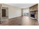 Inviting living room boasts wood floors, a stone fireplace, and a sliding glass door to a private balcony at 14454 E Colorado Dr # 102, Aurora, CO 80012