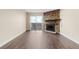 Bright living room features modern flooring, a stone fireplace, and access to the balcony at 14454 E Colorado Dr # 102, Aurora, CO 80012