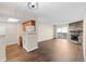 Spacious living space with a view of the kitchen, fireplace, and balcony at 14454 E Colorado Dr # 102, Aurora, CO 80012