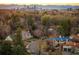 Aerial view of neighborhood homes and nearby Denver skyline with mountain views at 6 Ivy Ln, Denver, CO 80220
