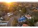 Aerial view of neighborhood and nearby Denver skyline during sunset at 6 Ivy Ln, Denver, CO 80220