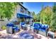 Relaxing backyard patio area features blue outdoor furniture and a blue fire pit, shaded by a blue awning at 6 Ivy Ln, Denver, CO 80220