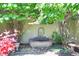 Stone water fountain framed by mature trees and shrubs in a private backyard setting at 6 Ivy Ln, Denver, CO 80220