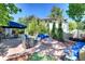 Backyard patio area with blue cushioned seating, built in bench and tile-lined fire pit at 6 Ivy Ln, Denver, CO 80220