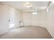 Finished basement with painted wood paneling, neutral carpet, and an exterior access door at 6 Ivy Ln, Denver, CO 80220