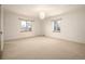 Bright, carpeted room with dual windows and modern lighting at 6 Ivy Ln, Denver, CO 80220