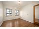 Inviting bedroom with hardwood floors and natural light streaming through large windows at 6 Ivy Ln, Denver, CO 80220