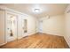 A bright bedroom features hardwood floors, neutral walls, and doorways to the bathroom and closet at 6 Ivy Ln, Denver, CO 80220