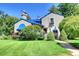 Charming home featuring a blue tile roof, lush landscaping, and a well-manicured lawn at 6 Ivy Ln, Denver, CO 80220