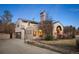Charming stucco home with unique architectural details, blue tile roof, and landscaped front yard at twilight at 6 Ivy Ln, Denver, CO 80220