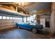 Spacious garage featuring a classic blue convertible car, ample storage, and overhead lighting at 6 Ivy Ln, Denver, CO 80220