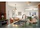 Bright kitchen features a stainless steel sink, dark cabinets, and views into the living room and breakfast nook at 6 Ivy Ln, Denver, CO 80220