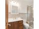 Bathroom with wood cabinet, quartz countertop, and glass enclosed shower at 6246 W 35Th Ave, Wheat Ridge, CO 80033
