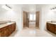 Elegant bathroom featuring dual vanities and a glass-enclosed shower and jacuzzi tub at 6246 W 35Th Ave, Wheat Ridge, CO 80033