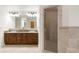 Bathroom featuring double sinks with warm wood cabinets and granite countertops at 6246 W 35Th Ave, Wheat Ridge, CO 80033