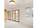 Bright bedroom featuring a classic chandelier and walkout to balcony with railing at 6246 W 35Th Ave, Wheat Ridge, CO 80033