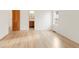Bright empty room with hardwood floors, white walls, window, and wooden door at 6246 W 35Th Ave, Wheat Ridge, CO 80033