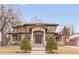Stunning two-story home with a tile roof, symmetrical landscaping, and a grand entrance with pillars at 6246 W 35Th Ave, Wheat Ridge, CO 80033