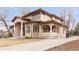 Beautiful home with a tile roof, columns, and mature landscaping, showcasing its architectural details at 6246 W 35Th Ave, Wheat Ridge, CO 80033