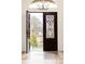 Elegant foyer with decorative tile flooring, a grand chandelier, and ornate wrought iron and glass front doors at 6246 W 35Th Ave, Wheat Ridge, CO 80033