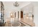 Inviting foyer features a decorative tiled floor, chandelier, and entry to the home's bright and airy living spaces at 6246 W 35Th Ave, Wheat Ridge, CO 80033