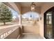 Charming front porch with decorative columns and a hanging lantern, offering a welcoming outdoor space at 6246 W 35Th Ave, Wheat Ridge, CO 80033