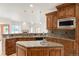 Spacious kitchen with custom wood cabinets, granite countertops, and modern appliances at 6246 W 35Th Ave, Wheat Ridge, CO 80033