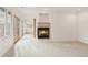 Bright living room featuring plush carpeting, windows, fireplace, and sliding glass doors at 6246 W 35Th Ave, Wheat Ridge, CO 80033