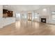 Open-concept living area with hardwood floors, a decorative fireplace, and views into the kitchen at 6246 W 35Th Ave, Wheat Ridge, CO 80033