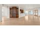 Open-concept living area showcasing hardwood floors, built-in shelving, and a kitchen area at 6246 W 35Th Ave, Wheat Ridge, CO 80033
