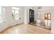 Elegant living space showcases front door, hardwood floors, and arched doorways leading to other rooms at 6246 W 35Th Ave, Wheat Ridge, CO 80033