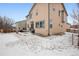 Two-story home with backyard patio, surrounded by a snow-covered lawn at 17395 Leisure Lake Dr, Monument, CO 80132