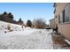 Snowy backyard with patio and partial fencing at 17395 Leisure Lake Dr, Monument, CO 80132