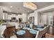 Bright dining area adjacent to kitchen, featuring a large chandelier at 17395 Leisure Lake Dr, Monument, CO 80132