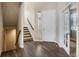 Bright entryway with hardwood floors, stairs, and French doors at 17395 Leisure Lake Dr, Monument, CO 80132