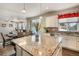 Kitchen island with granite countertop, overlooks dining and living areas at 17395 Leisure Lake Dr, Monument, CO 80132