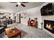 Living room with a fireplace, open floor plan, and kitchen view at 17395 Leisure Lake Dr, Monument, CO 80132