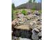 Serene backyard water feature with rocks and cascading water at 17395 Leisure Lake Dr, Monument, CO 80132