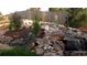 Multi-tiered backyard waterfall with lush landscaping at 17395 Leisure Lake Dr, Monument, CO 80132