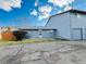 A charming home exterior showcasing the side yard, garage, and blue siding against a bright, sunny sky at 1049 W 112Th Ave # A, Denver, CO 80234