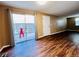 Living room featuring sliding door to patio, light brown walls, and wood floors at 1049 W 112Th Ave # A, Denver, CO 80234