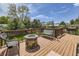 Outdoor deck featuring a fire pit, porch swing, and comfortable seating, perfect for outdoor relaxation and entertainment at 1488 W 102Nd Ave, Northglenn, CO 80260