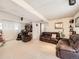 Spacious basement with comfortable seating, built-in shelving, and neutral carpeting at 1488 W 102Nd Ave, Northglenn, CO 80260