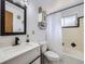 Modern bathroom featuring white vanity, black fixtures, and shower/tub combination at 1488 W 102Nd Ave, Northglenn, CO 80260