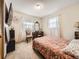 Bedroom featuring carpet floors, two windows, curtains, dresser and bed with floral comforter at 1488 W 102Nd Ave, Northglenn, CO 80260