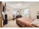 Cozy bedroom boasts bright natural light, complemented by a classic vanity and chair at 1488 W 102Nd Ave, Northglenn, CO 80260
